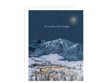 May include: A watercolor painting of a snowy mountain scene with a small village at the bottom of the mountain. The sky is dark blue with a single bright star and the text "all is calm, all is bright" is written in white.