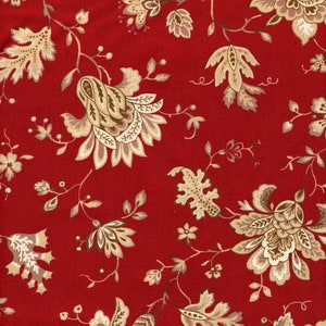May include: A close-up of a red fabric with a floral pattern. The design features beige and brown flowers, leaves, and vines. The flowers have detailed petals and are scattered across the red background.