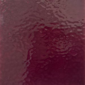 May include: A square, textured surface with a deep burgundy color. The surface has a rippled appearance, with variations in tone and highlights. The overall effect is a glossy, reflective finish.
