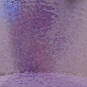 May include: Abstract background with a textured, iridescent surface. The color palette transitions from light lavender to deep purple, with hints of blue. The surface has a mottled appearance, suggesting a watercolor or painted effect.