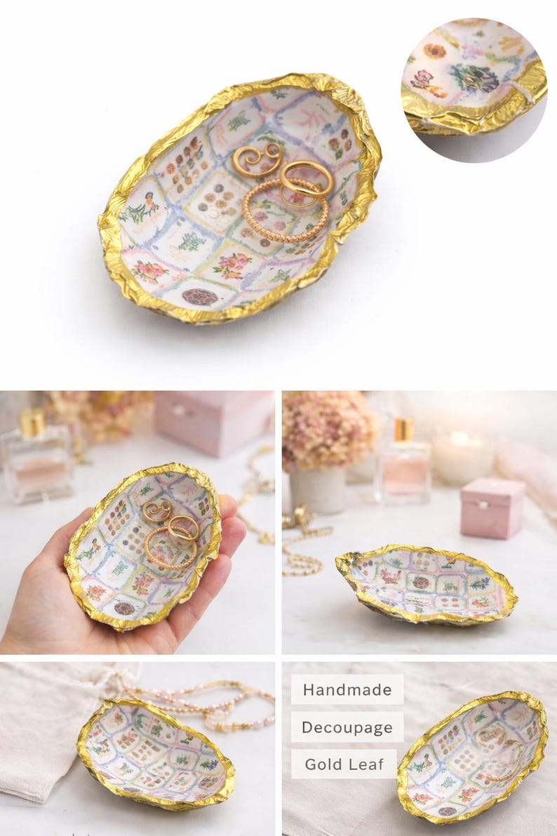 May include: An oval-shaped oyster shell trinket dish featuring a decoupage interior with a grid of floral and botanical illustrations. The edges of the shell are finished with a textured gold leaf trim. The dish holds three gold-toned rings.
