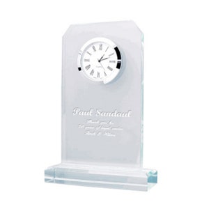 May include: A clear glass clock with a silver face and black hands. The clock is engraved with the text "Paul Sandau. Thank you for 30 years of loyal service. Beck & Wilson."