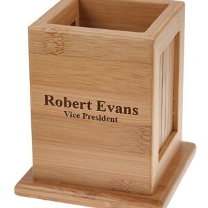 May include: A natural bamboo desk organizer with a personalized inscription that reads "Robert Evans Vice President".