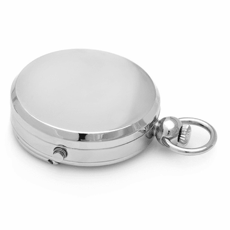 May include: A silver pocket watch with a round face and a chain attached to the top.