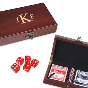 May include: A mahogany wood box with a brass latch, engraved with the initials "JKF". The box contains two decks of playing cards and five red dice.