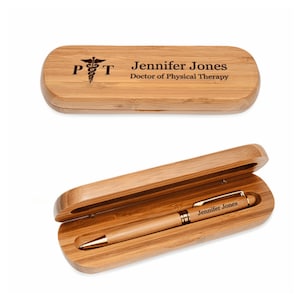 May include: A wooden pen and pencil holder with a gold pen inside. The holder is engraved with the text "Jennifer Jones, Doctor of Physical Therapy" and a medical symbol.