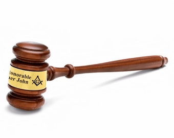 May include: A brown wooden gavel with a gold band that reads "Honorable Brother John" and a Masonic symbol.