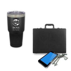 May include: A black stainless steel travel mug with a white globe graphic and the text "The World Is My" and "BOSS Eric Patrick". The mug is next to a black briefcase, a black tablet, and a set of keys.