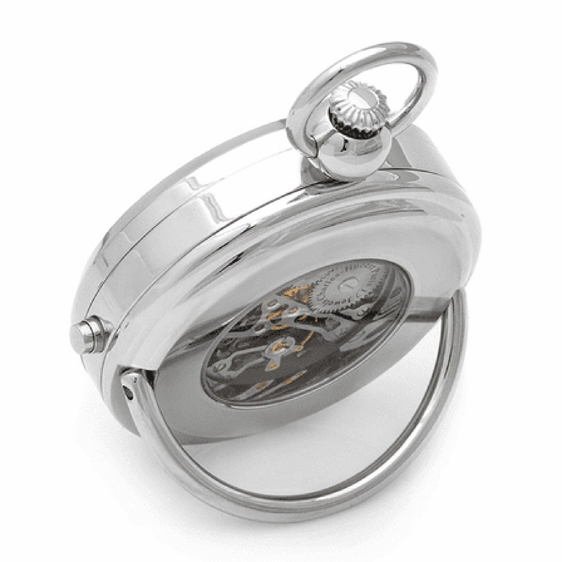 May include: A silver pocket watch with a clear back revealing the intricate mechanical workings. The watch has a hinged loop for attaching to a chain.
