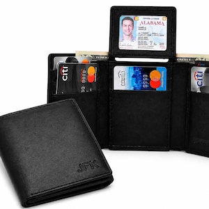 May include: A black leather tri-fold wallet with the initials JFK embossed on the front. The open wallet displays multiple card slots containing credit cards and an Alabama driver license in a clear plastic window, with paper currency visible.
