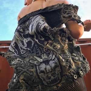 May include: A black denim jacket with various patches, including a skull, an octopus, and crossbones. The jacket is ripped and distressed, giving it a punk rock aesthetic.