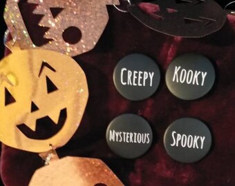 May include: Four black round buttons with white text. The buttons read "Creepy", "Kooky", "Mysterious", and "Spooky".