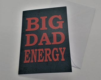 May include: A black card with the text "BIG DAD ENERGY" in red letters on a textured background.