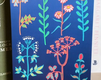 May include: A blue card with a colorful illustration of various flowers and plants. The flowers are in shades of red, yellow, white, and orange. The plants are in shades of green, blue, and orange.