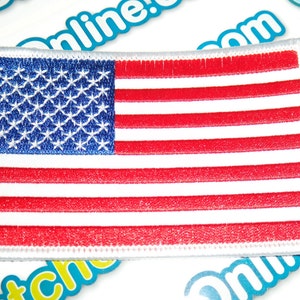 May include: A white embroidered patch with the American flag. The flag is red, white, and blue with 13 red and white stripes and 50 white stars on a blue field.