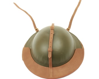 May include: A green military helmet with a brown leather chin strap and a brown leather strap that goes over the top of the head.