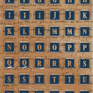 May include: Sheet of Alpha Bubble Stickers with gold trim and navy blue letters and numbers. The stickers are on a background of handwritten script. The text "Alpha Bubble Stickers" is at the top.
