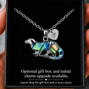 Abalone shell otter necklace presented in a black gift box with optional personalised heart initial charm on a silver-tone chain.