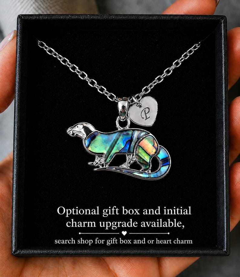 Abalone shell otter necklace presented in a black gift box with optional personalised heart initial charm on a silver-tone chain.