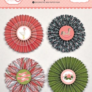 May include: Four decorative mini paper fans by Carta Bella. One fan is red with a white plaid pattern and a goose illustration. One is dark with a floral print and a rocking horse. One is a red and white plaid with the text Sweet Bundle of Joy. One is green.
