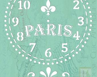 May include: A white stencil with a clock face design. The clock face has Roman numerals and a fleur-de-lis in the center. The words "PARIS" are written in a decorative font below the clock face. The stencil is on a light blue background.