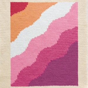 May include: A knitted square with a geometric pattern of diagonal stripes in shades of pink, orange, and white. The stripes are arranged in a wave-like pattern.