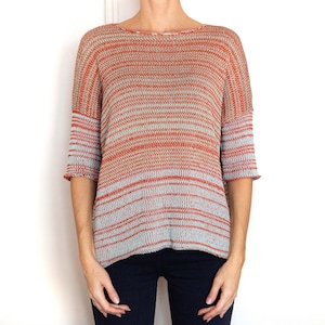 May include: A striped, orange and blue, knitted sweater with a relaxed fit and three-quarter sleeves.