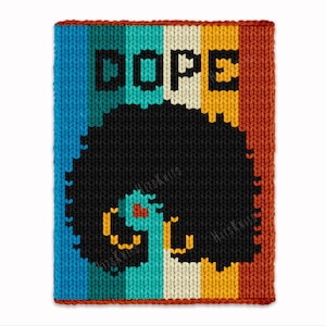 May include: A knitted wall hanging with the word "DOPE" in black block letters. The design features a black afro with teal, orange, and yellow accents. The background has vertical stripes of blue, teal, cream, yellow, and orange.