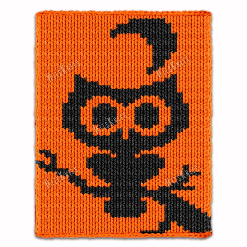 May include: Orange knitted square with a black cat design. The cat has large eyes and a curved tail. The design is made with a textured knit stitch.