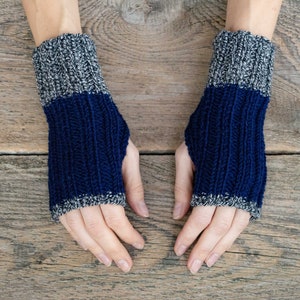 May include: A pair of blue and gray fingerless gloves with a ribbed knit pattern.