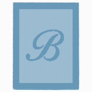 May include: A pale blue blanket featuring a large letter "B" in a darker shade. The blanket has a textured weave and a border with darker blue stripes. The design is simple and would suit a variety of interiors.