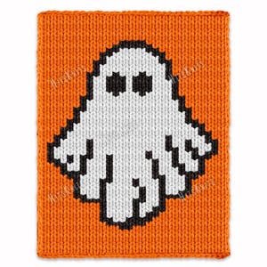 May include: A knitted orange square with a white ghost design outlined in black. The ghost has two black eyes and a simple, pixelated design. The background is a solid orange color, and the overall style is reminiscent of Halloween.