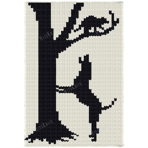 May include: A rectangular knitted textile featuring a black and white pattern. The design depicts a black tree silhouette against a white background, with a black cat perched on a branch and a black dog standing on its hind legs near the tree trunk.