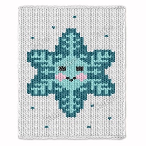 May include: A white knitted square with a teal snowflake design. The snowflake has a smiling face with pink cheeks and is surrounded by small teal dots. The design is a cozy, winter-themed pattern.