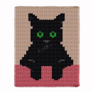 May include: Knitted cat design in black with green eyes, set against a tan background and a pink base. The image features a square, textured pattern, likely a blanket or pillow. The cat's silhouette is simple, with a cute, cartoonish appearance.