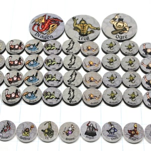 May include: A collection of round game tokens featuring fantasy characters and creatures. The tokens include illustrations of a dragon, troll, ogre, and various other characters like goblins, guards, and skeletons. Each token is gray with a character illustration and a name.