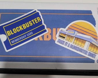 May include: A blue VHS tape case with a white sticker that says "Blockbuster Membership Card" and a sticker of a Blockbuster store with the text "Make it a Blockbuster Night". The case has the title "Hellraiser" printed on the front.
