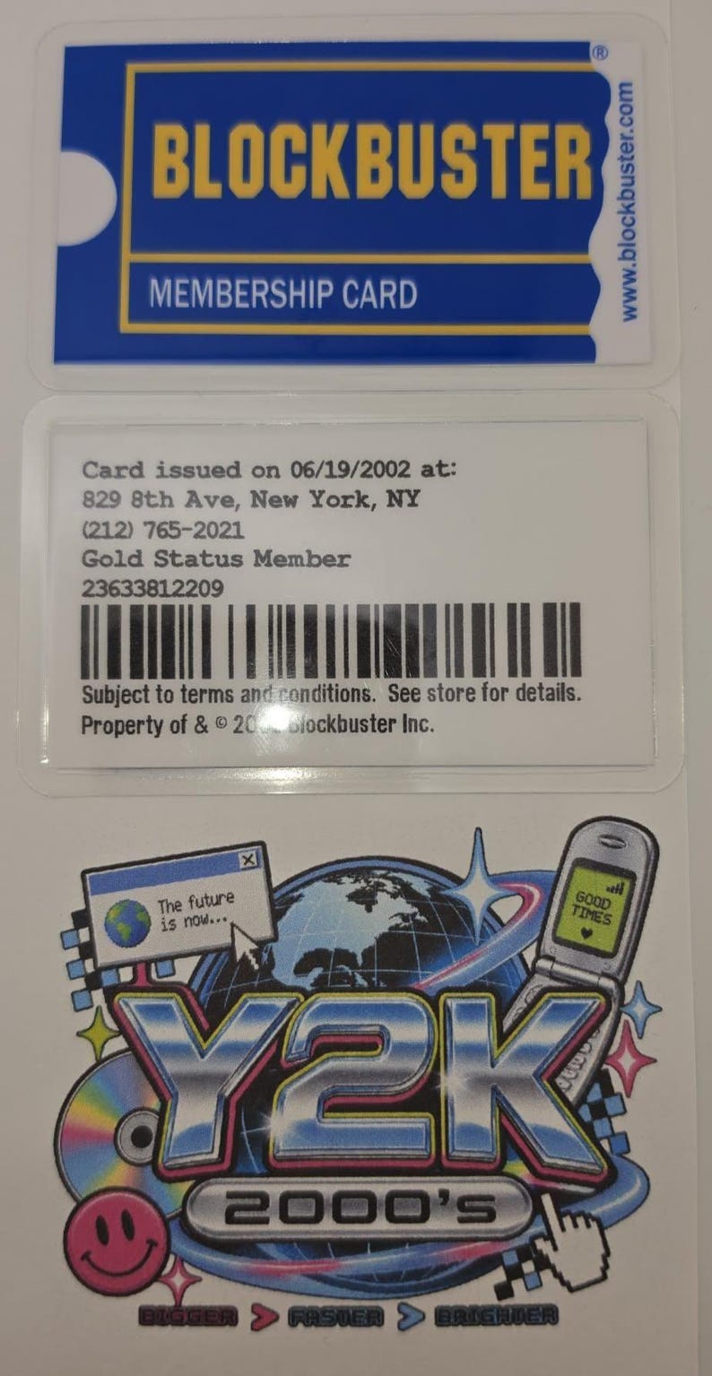 May include: A Blockbuster membership card with blue and yellow branding, showing issue date 06/19/2002, address, and barcode. Below is a Y2K 2000's sticker featuring a flip phone, a computer window with text The future is now, and a smiley face icon.