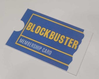 May include: A blue and yellow Blockbuster membership card with the text "Blockbuster Membership Card" printed on it.