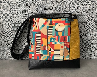 Tote bag, adjustable shoulder strap, colorful abstract music patterns, small white polka dot patterns on yellow, black leather, recycled handmade Quebec