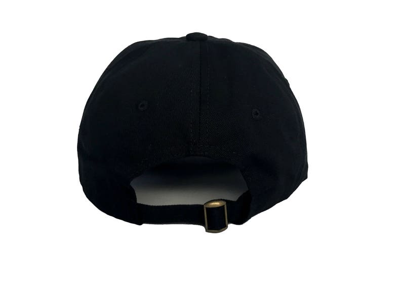 May include: A black baseball cap with a simple design. The cap has a curved brim and an adjustable strap at the back.