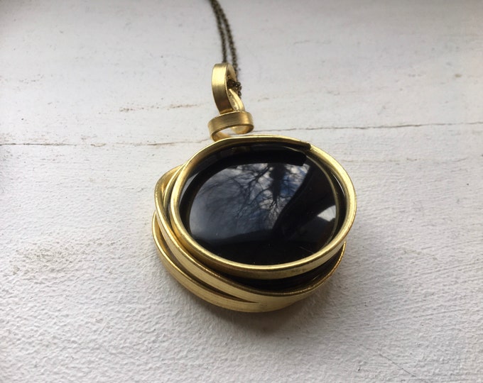 Black onyx gemstone wrapped with brass.  handmade round statement pendant