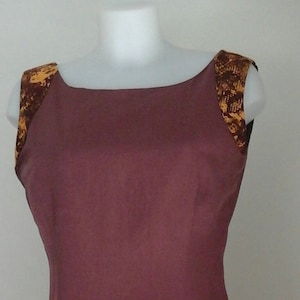Dress in wax and linen. flared inside and box pleats at the bottom