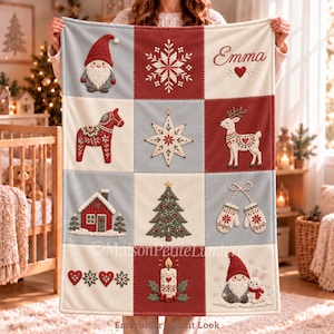 Könnte beinhalten: Eine rechteckige Wohndecke mit einem Raster aus zwölf bestickten Quadraten im Weihnachtsthema. Die Motive zeigen einen Wichtel, eine Schneeflocke, den Namen Emma mit einem Herz, ein Dala-Pferd, einen Stern, ein Rentier, ein Haus, einen Tannenbaum, Fäustlinge, Herzen, eine Kerze sowie einen Wichtel mit einem Hasen.