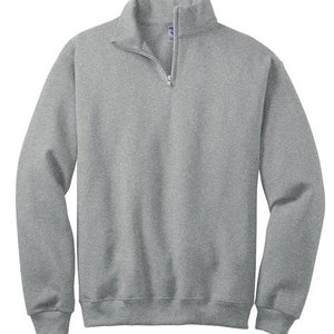 May include: A heather gray long-sleeve sweatshirt featuring a quarter-zip neckline with a silver-toned metal zipper pull. The garment has a stand-up collar, ribbed cuffs at the wrists, and a ribbed hemline at the bottom, providing a structured fit.