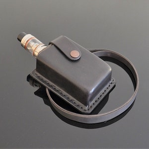 May include: A black leather case with a brown button and a strap for carrying a vape pen.