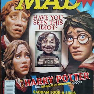 May include: A MAD Magazine cover featuring caricatures of Harry Potter characters. The cover includes the headline "HAVE YOU SEEN THIS IDIOT?" and the text "HARRY POTTER OUR MAGICALLY MORONIC SPOOF!" Additional text includes "SADDAM LOOK-A-LIKES WHERE ARE THEY NOW?" and "13 THINGS YOU REALLY LEARN IN SUMMER SCHOOL!"