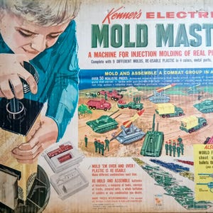 May include: Vintage Kenner's Electric Mold Master toy set box. The box features a child using the mold machine. The box art shows various plastic toy vehicles and weapons, including tanks, trucks, and missile launchers. The box also includes text that reads "Mold and Assemble a Combat Group in Action!"