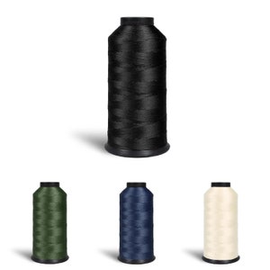 May include: Four spools of thread in different colours: black, green, blue, and beige. The spools are all the same size and shape, and they are arranged in a row.