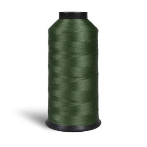 May include: A spool of dark green thread.